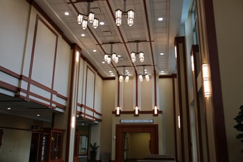 Example efficiency project to remove a Midwest hospital's cost of waiting, by Fairbanks Energy Services, image of large lights hanging from a ceiling